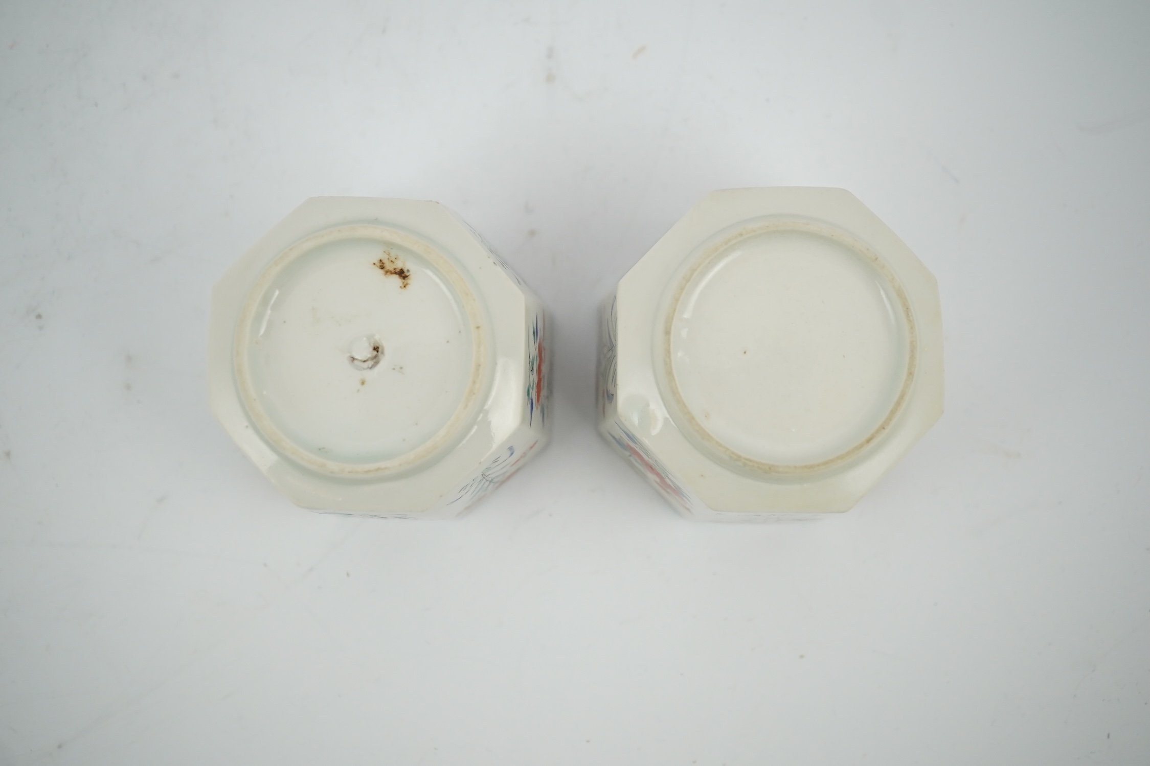 A pair of Japanese kakiemon octagonal porcelain cups, probably Edo period, 5.5cm high. Condition - one restored the other hairline cracks